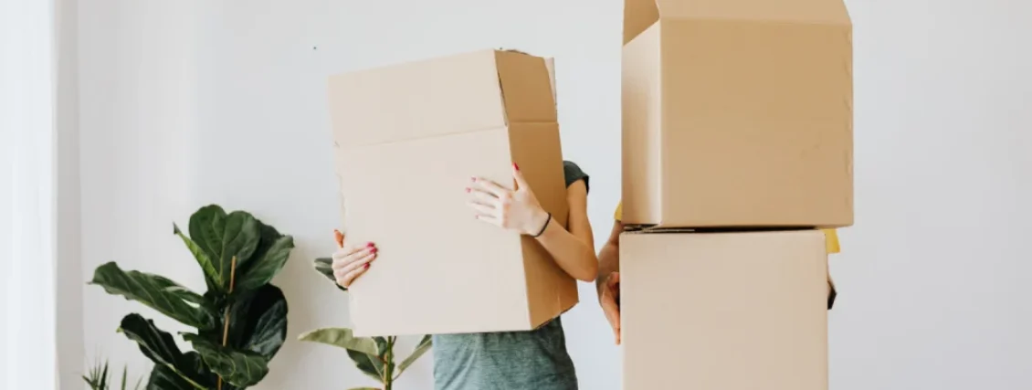 Couple placing furniture removal boxes inside their house in Sydney during relocation day.