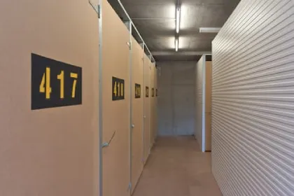 Indoor storage units along a corridor with roller doors