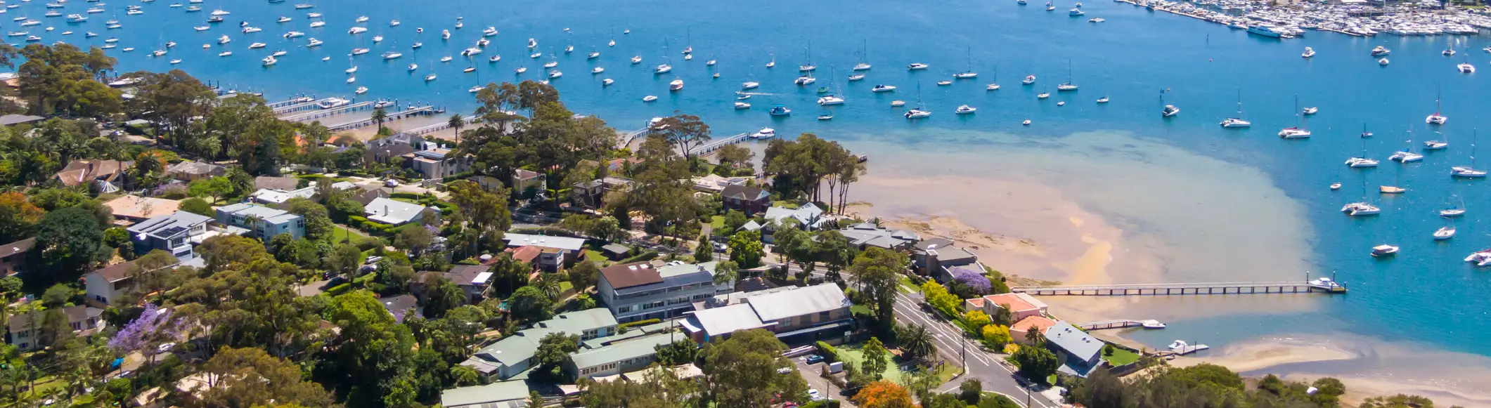 Drone view over Bayview on Sydney's Northern Beaches with waterfront homes and Pittwater views