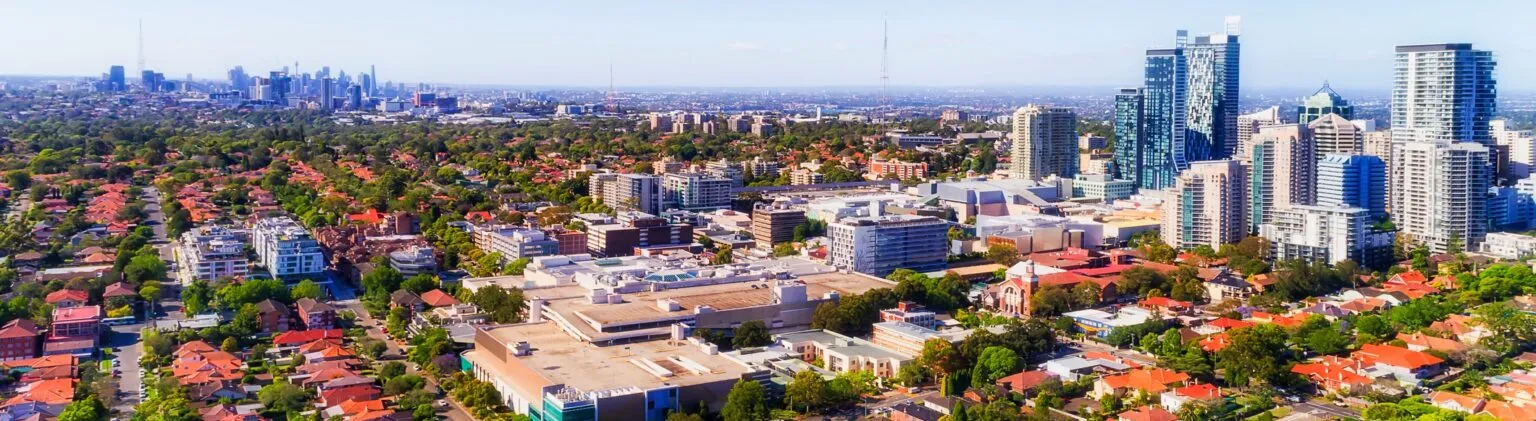 Aerial view of Chatswood’s high-rise skyline beside leafy Willoughby residential streets